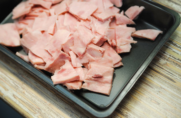 many meat sliced on a roasting pan
