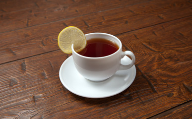 Cup of tea with lemon on a wooden table
