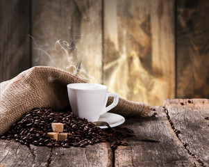 Coffee on a wooden table. Dark background.