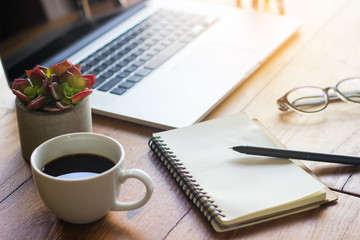 Pen on the side of the coffee cup on the desk