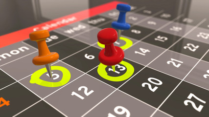 Marking day in calendar. Different days of the month are marked with a pushpin.