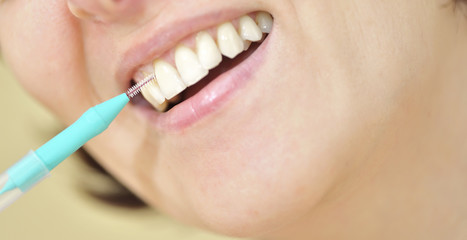 Naklejka premium Teeth with an interdental brush