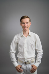 Business man in white shirt, portrait on grey background.