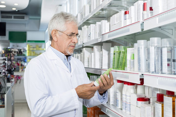 Senior Chemist Holding Product In Pharmacy