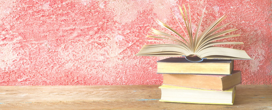 opened book, on red grungy background, panoramic, copy space