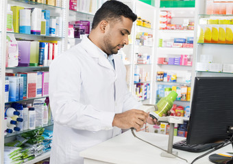 Chemist Scanning Barcode Of Product At Counter