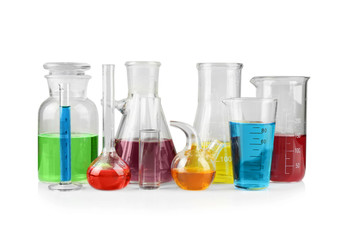 Different chemical glassware with color water on white background