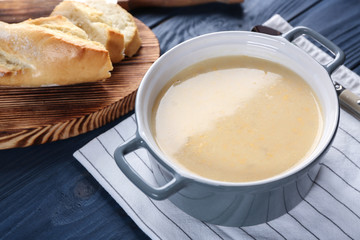 Delicious cream soup in pan on table