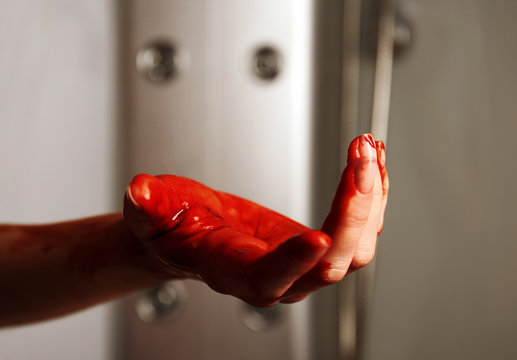 Bloody hand of depressed woman in shower