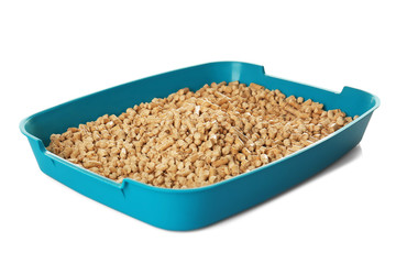 Plastic litter box with filler on white background