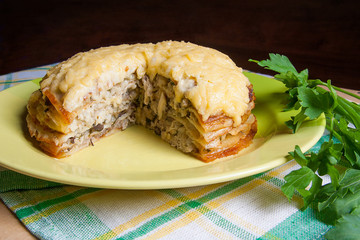Close up view of cutted pancakes pie with mushrooms and chicken meat. Traditional meal for Maslenitsa - Russian pancake week.