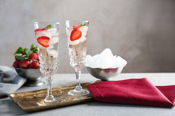 Glasses with delicious wine spritzer on golden tray