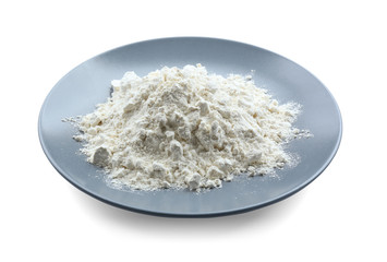 Plate with flour on white background