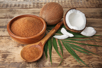 Bowl and spoon of coconut sugar on wooden background