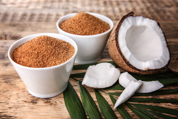 Bowls of coconut sugar on wooden background