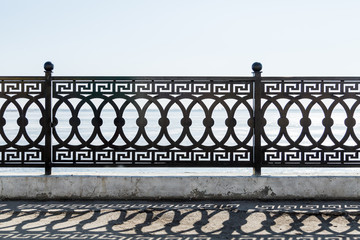 The iron fencing on the waterfront.