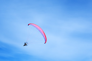 Flight moto paraglider on the sky background 