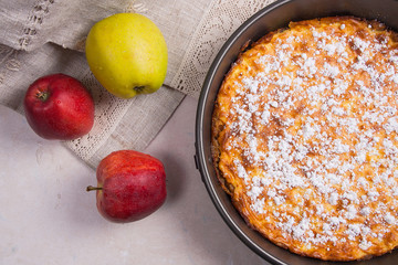 Apple pie with fresh fruits on light marble background