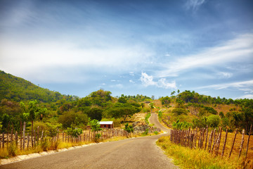 Fototapeta na wymiar the road to Pico Isabel de Torres, Puerto Plata, through the countryside and a sun scorched landscape