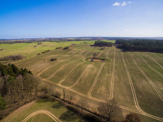 Fototapeta premium Aerial view of agricultural fields in spring with blue sky - germany