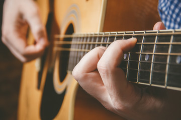 Fototapeta premium Close up of guitarist hand playing guitar