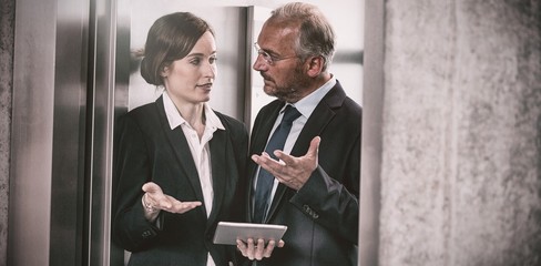 Businessman with colleague in elevator