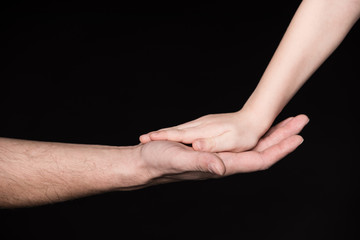Father and child touching palms