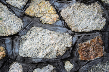 Texture of granite stone wall as a background