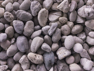 White stone texture, pile of white stones, close-up of the white pebbles, white rocks for background or texture,