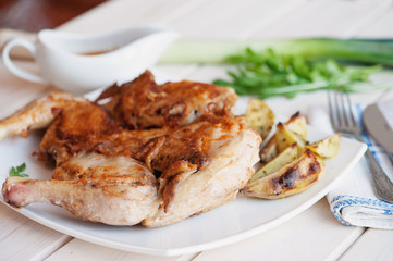 Roasted whole chicken on dish with cutlery