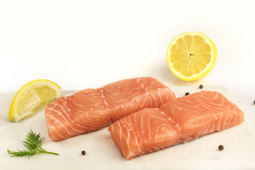 Two slices of salmon on white background with copyspace