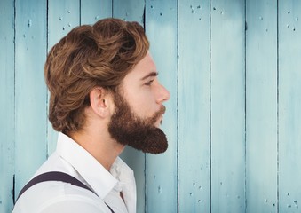 Man with beard against blue wood panel
