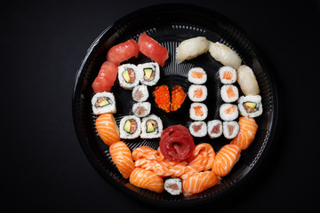 A large set of sushi and rolls view from above. A lot of food in one plate. Dishes from raw fish Japanese food.A dish in a romantic style. I love you. Heart with red fish caviar