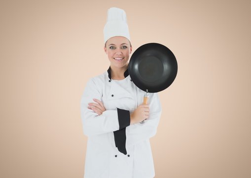 Chef with frying pan against cream background