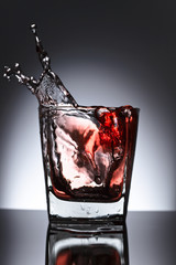 Glass of whiskey with ice on a black background
