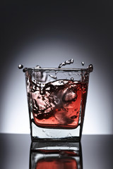 Glass of whiskey with ice on a black background