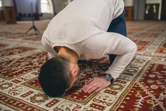 Muslim prostrating in prayer with his fore-head on the floor