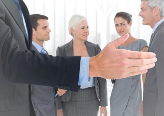 Handshake in front of business people at window