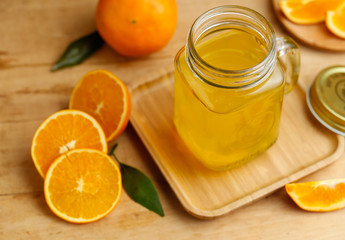 Naklejka na ściany i meble Orange juice and oranges on retro wooden desk