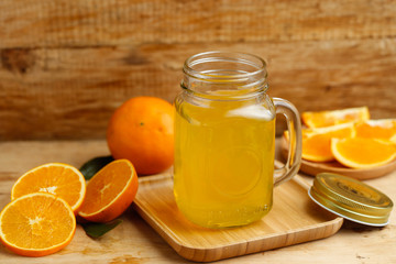 Obraz na płótnie Canvas Orange juice and oranges on retro wooden desk