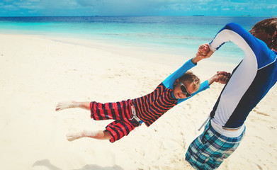 father and son playing on beach