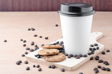 Coffee cup and coffee beans on wooden background