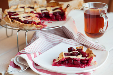 Homemade cherry pie on rustic background