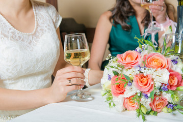 Wedding. Wedding party with guests. Hands of the groom and the bride with glasses. Newlyweds celebrate wedding day
