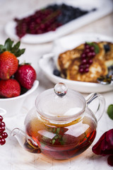 glass teapot with black tea