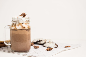 Hot chocolate with marshmallow on the wooden background. Shallow depth of field.