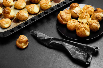 Profiteroles eclairs .Eclair on baker tray defocused.Copy space Selective focus