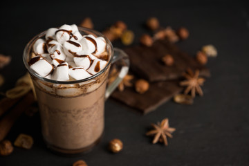 Hot chocolate with marshmallow on the wooden background. Shallow depth of field.