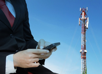 double exposure of businessman in suit and red necktie using smart phone with global media connection on telecommunication tower background, network connection and technology concept color tone effect