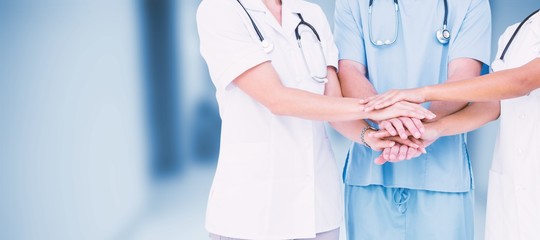 Composite image of midsection of doctors putting hands together
